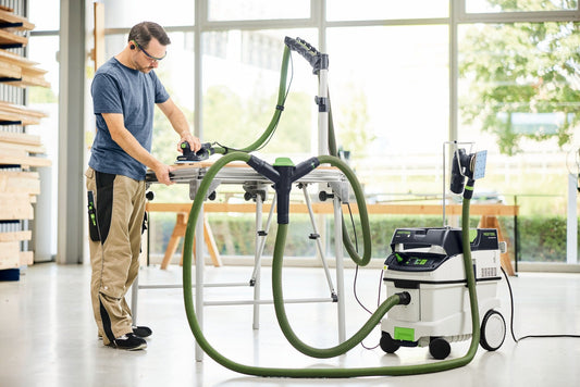 Festool Saugschlauch in Anwendung mit CT Absaugmobil und Elektroschleifermaschine bei Holzbearbeitung.