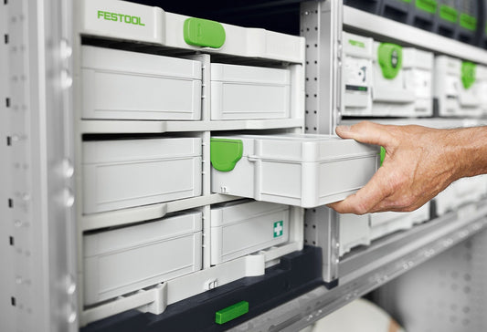 Festool Systainer³ SYS3 S 76 mit grünem Handgriff wird aus Regal gezogen, transparenter Deckel sichtbar